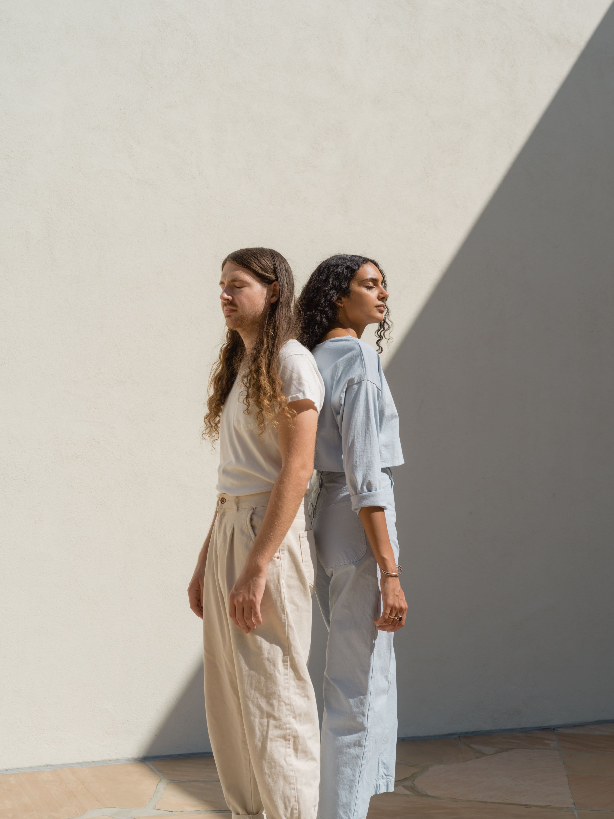 Trendy Man And Woman Standing With Shadow